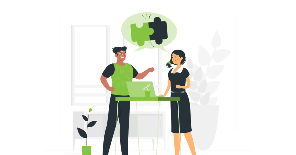 two people collaborating around a desk and computer with a plan on the side - simplified collaboration