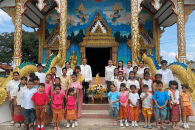 childrends and thier guardian standing infront of a beautiful temple